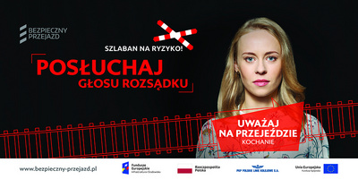Billbord kampanii, tekst Uważaj na przejeździe kochanie, postać kobiety